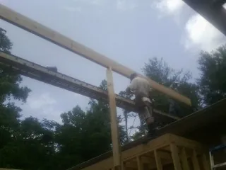 Carpenter setting a ridge beam over a new addition frame — Ice Dam Removal by Roofing Brothers in San Lorenzo
