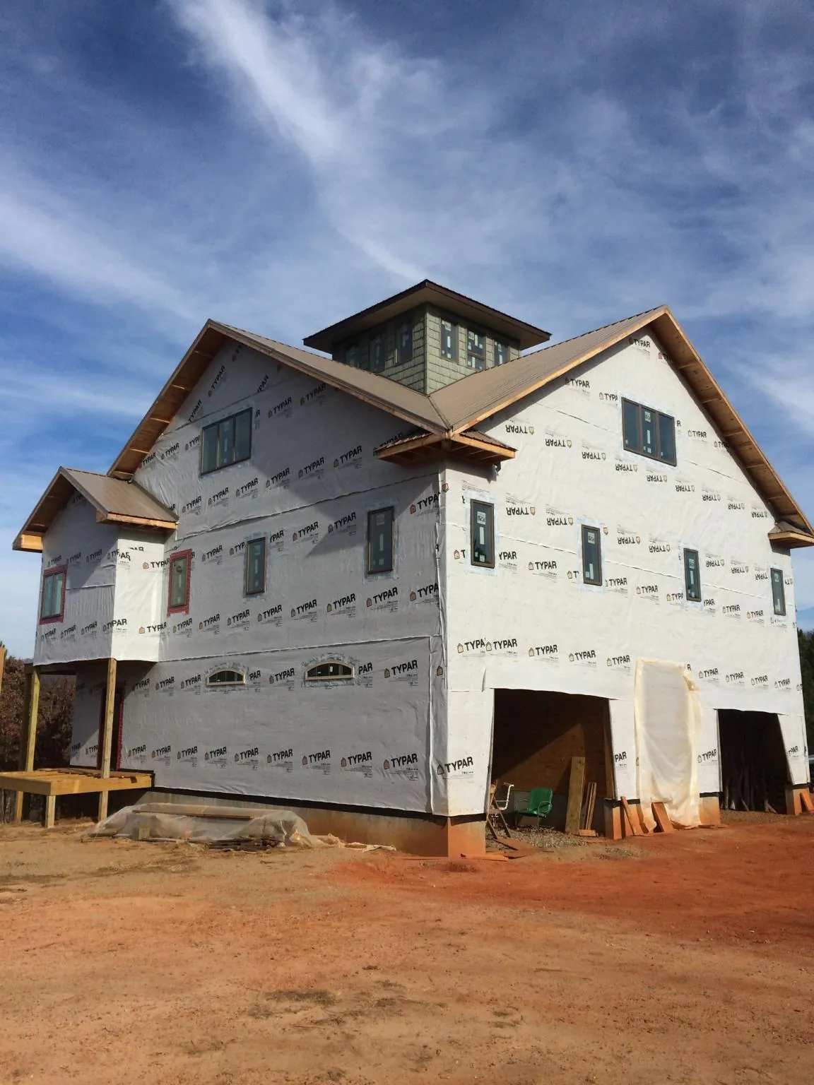 New two story house under construction with a cupola and gabled roofs in San Lorenzo